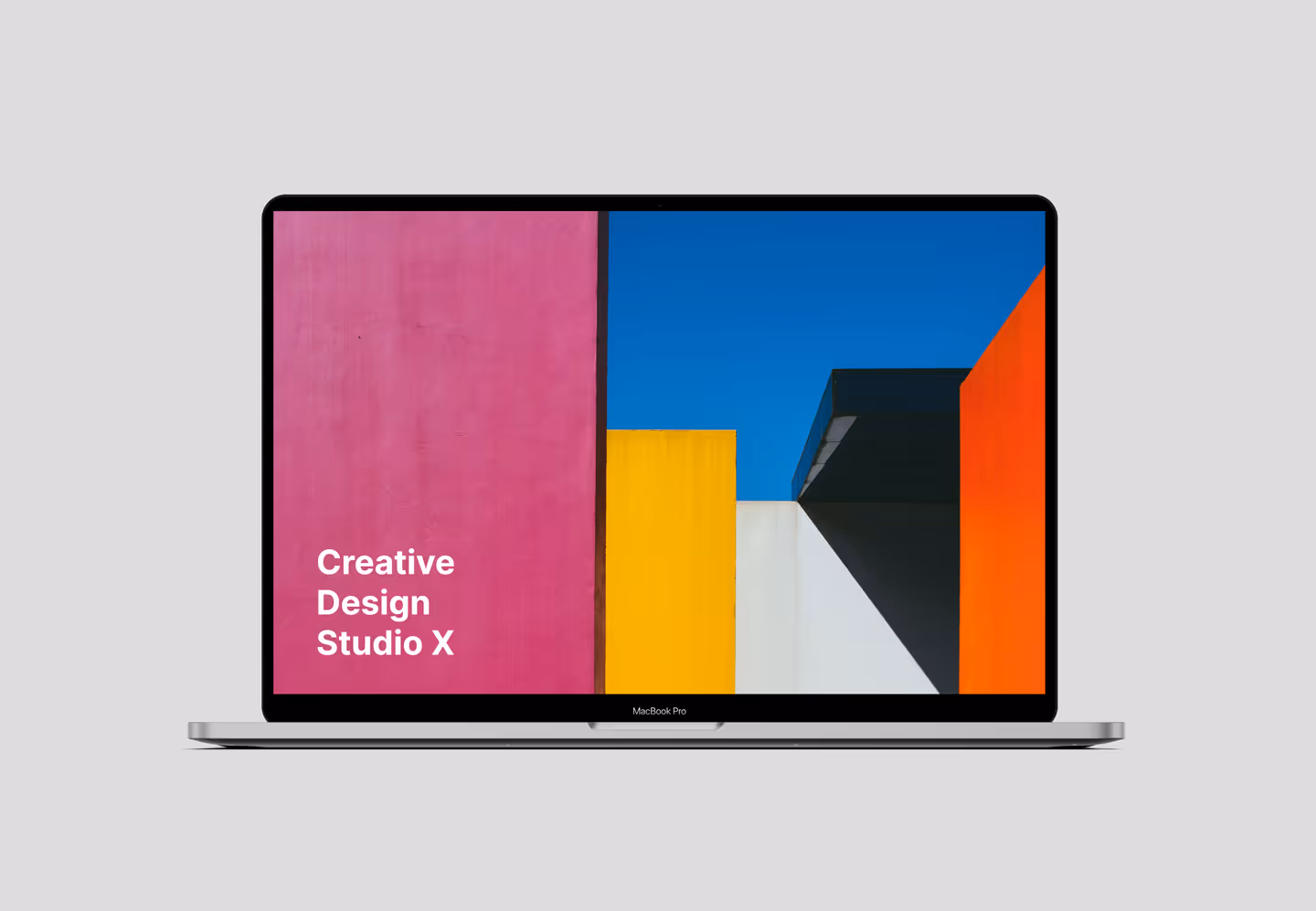 MacBook Pro displaying colorful Creative Design Studio X branding